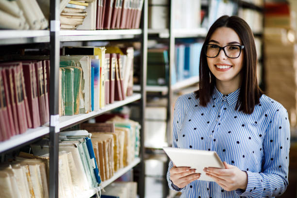istock Portrait of a gorgeous student using a tablet computer in a library 1135942374