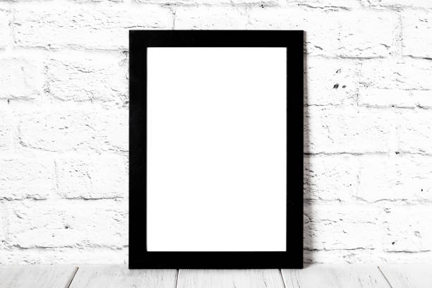 istock Empty black photo frame on wooden shelf or table. Mockup with copy space. 1135943466