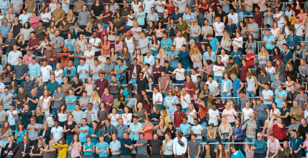 istock Group of spectators cheering in stadium 1135943537