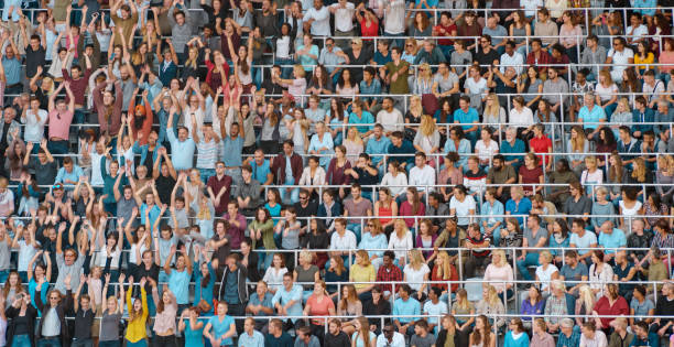 istock Group of spectators cheering in stadium 1135943538