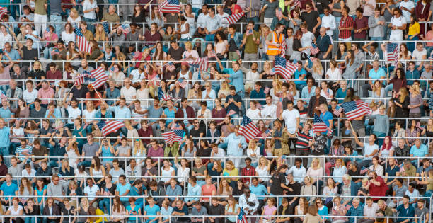 istock Group of spectators with flags at stadium 1135943544