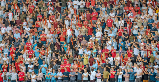 istock Group of spectators cheering in stadium 1135943552