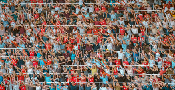 istock Spectators waving hands in stadium 1135943561