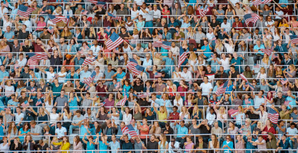 istock Group of spectators with flags at stadium 1135943562