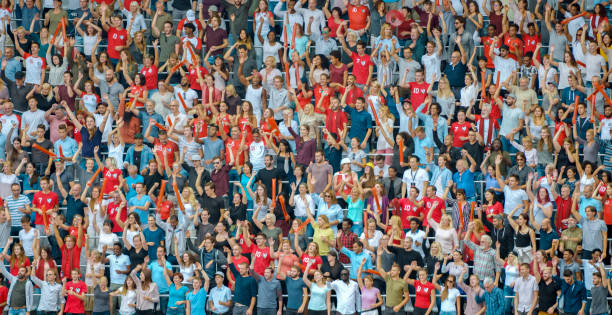 istock Group of spectators cheering in stadium 1135943566