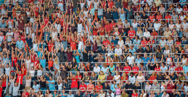 istock Group of spectators cheering in stadium 1135943567