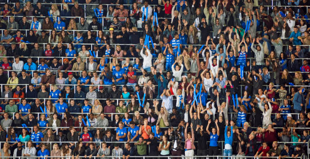 istock Group of spectators cheering in stadium 1135943568