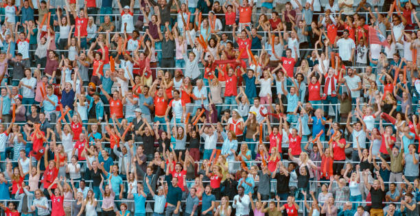 istock Group of spectators cheering in stadium 1135943570