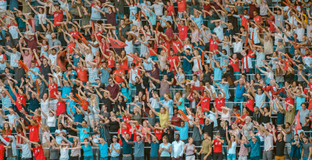 istock Spectators waving hands in stadium 1135943573