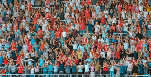 istock Group of spectators cheering in stadium 1135943576