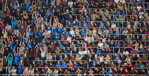istock Group of spectators cheering in stadium 1135943579