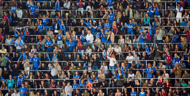 istock Group of spectators cheering in stadium 1135943581