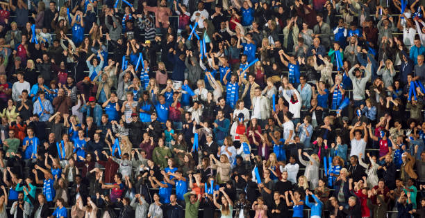 istock Group of spectators cheering in stadium 1135943582