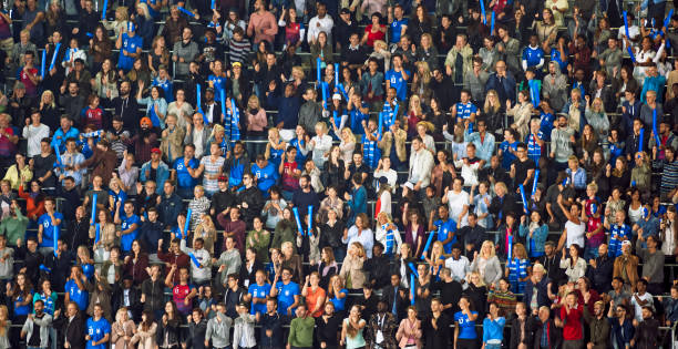 istock Group of spectators cheering in stadium 1135943588