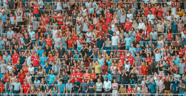 istock Group of spectators cheering in stadium 1135943594