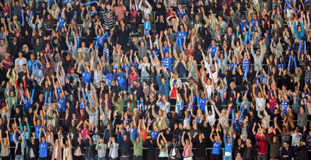 istock Group of spectators cheering in stadium 1135943595