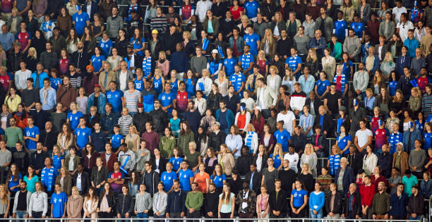 istock Spectators during National Anthem in stadium 1135943596