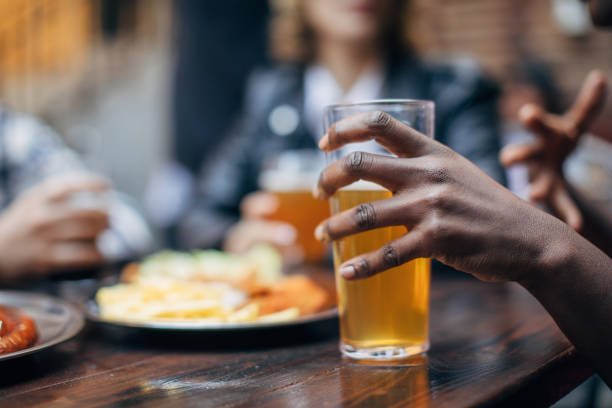 istock Black woman holding a beer glass 1135944075