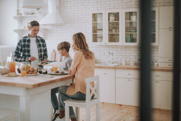 istock Family of three having breakfast in the kitchen 1135944237