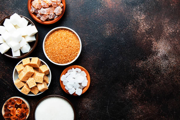 istock Set of different white and brown sugar in assortment, dark background, top view 1135944557