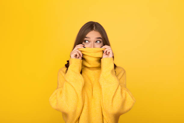 istock Woman having fun, looking out from sweater 1135947344