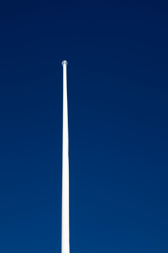 empty flagpole against blue sky