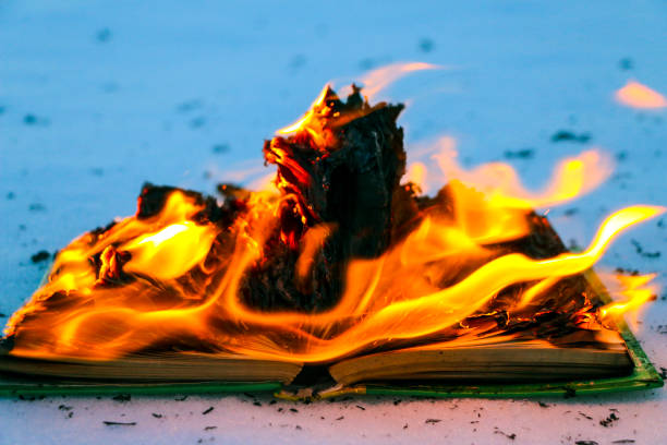 istock burning book in  snow. pages with the text in  open book burn with  bright flame. 1135948469