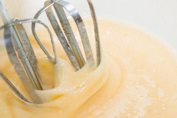istock Sugar is mixed with beaten egg for dessert 1135948581