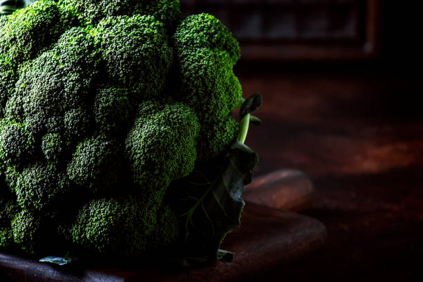 istock Big head of fresh green broccoli on dark rustic background, selective focus, minimalism 1135948707