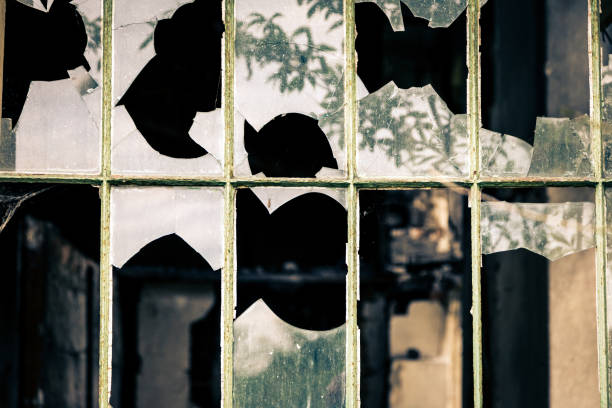 istock Smashed Glass Window of Derelict Abandoned Building 1135950071