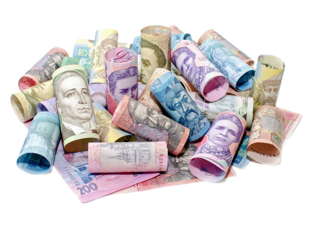 istock Curved banknotes of Ukrainian hryvnias on a white surface 1135950121