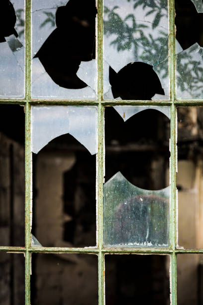 istock Smashed Glass Window of Derelict Abandoned Building 1135950309