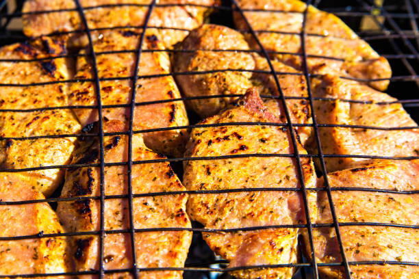istock Barbecue with delicious meat on the grill top view 1135951828