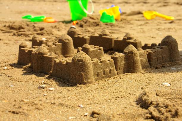 istock Sand castle and children toys on a beach 1135951862