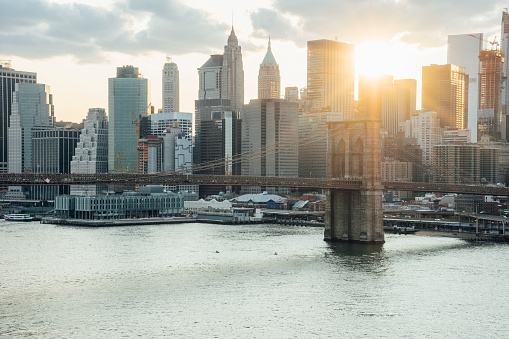 View of New York Skyline and Brooklyn Bridge during sunset