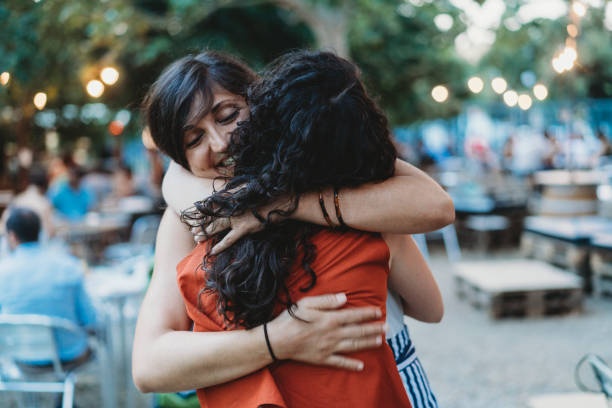 Two friends meeting up, hugging each other