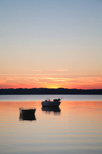 istock Boats on a lake in sunset, vertical 1135954499