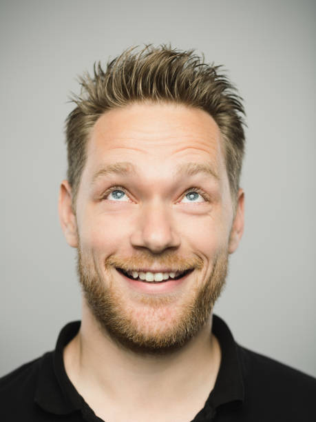 istock Portrait of real caucasian man with excited expression looking up 1135954642