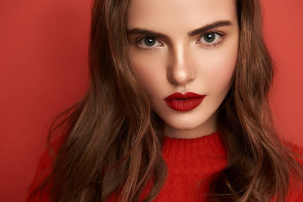 istock Attractive young lady with bright make up looking at camera indoors 1135955022
