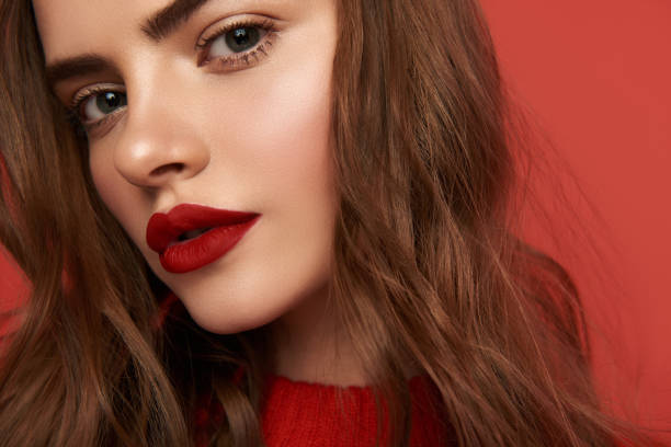 istock Low angle of young woman with bright make up looking at camera 1135955046