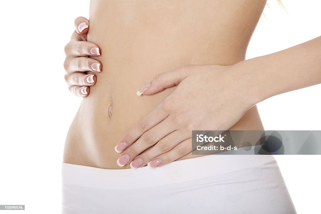 Healthy life A woman's hands on belly Hands On Stomach Stock Photo