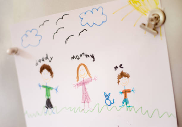Family Fridge Shot of Kid's family drawing on refrigerator door with magnets crayon drawing photos stock pictures, royalty-free photos & images