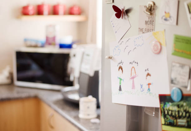 Kid's drawings on fridge Colorful kid's drawings and pictures decorated on kitchen refrigerator door crayon drawing photos stock pictures, royalty-free photos & images