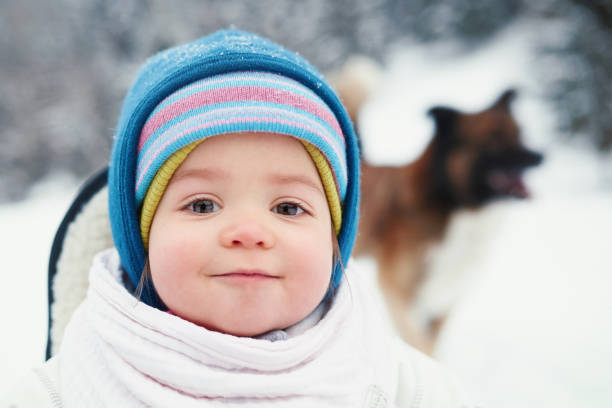 portrait of cute little girl in winter day looking at camera with her blue eyes.