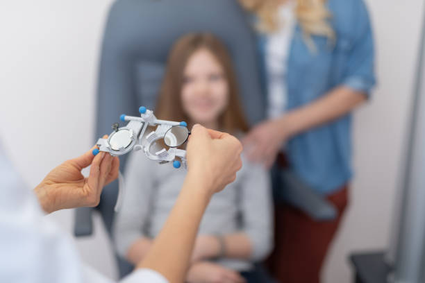 istock Ophthalmologist hands holding optometric trial frame for child 1135960456