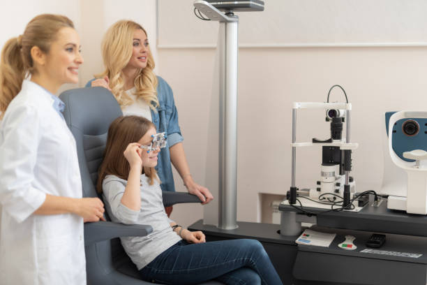 istock Optometrist examining child eyes with optical trial frame 1135960474
