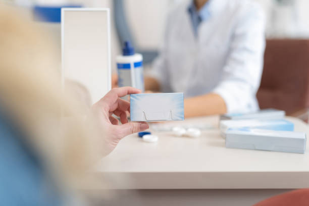istock Lady holding lenses packaging box in ophthalmologist cabinet 1135960490