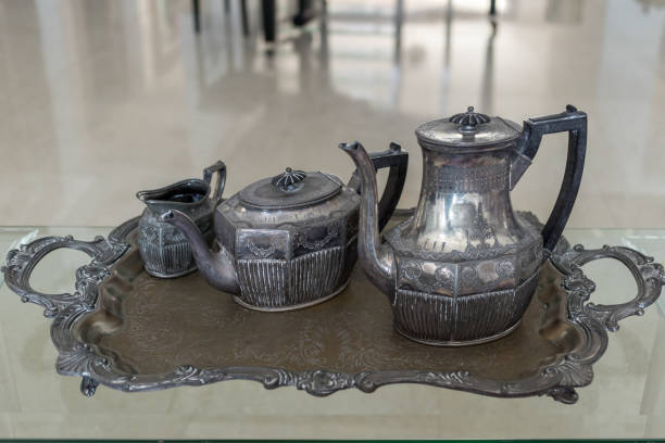 istock old antique silver teapot set on silver tray and glass table 1135961830