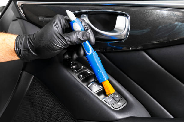 istock A man cleaning car with microfiber cloth and brush. Car detailing. Valeting concept. Selective focus. Car detailing. Cleaning car with brush. Worker cleaning. Car cleaning concept solution to clean. 1135962117