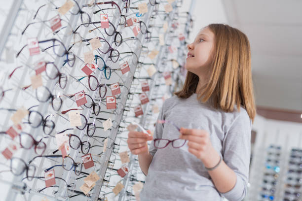 istock Low angle of a nice girl standing at the optical store 1135962891